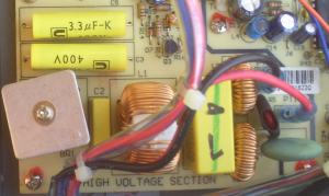 Close-up view of the High Voltage Section of a Peaktech 1540 switch mode lab power supply. Clearly visible is the bridge rectifier (w. heat sink, bottom left) and the two 3.3 uF smoothing caps (top left).