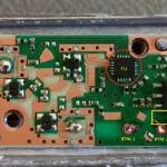 Closeup of the PCB with markings for the PLL, crystal pins and the printed circuit board inductor choke in front of the voltage regulator (yellow rectangle)