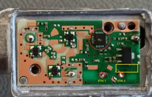 Closeup of the PCB with markings for the PLL, crystal pins and the printed circuit board inductor choke in front of the voltage regulator (yellow rectangle)