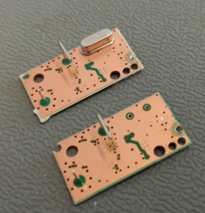 Two of the LNB PCBs before the modification (top) and after the removal of the 25 MHz crystal (bottom)