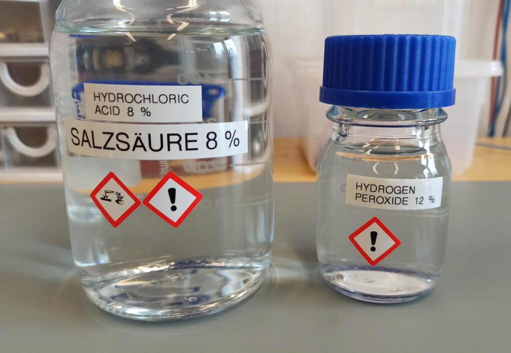 Two GL45 bottles containing 8 % hydrochloric acid (left) and 12 % hydrogen peroxide (right)