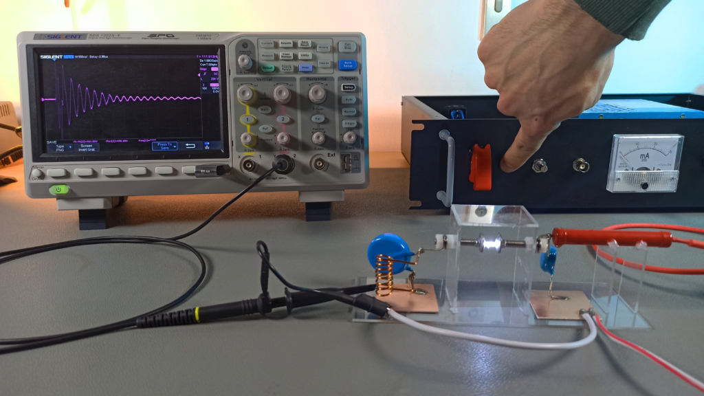 Test setup: High-voltage power supply (right), DIY spark gap transmitter (center) and oscilloscope (left)
